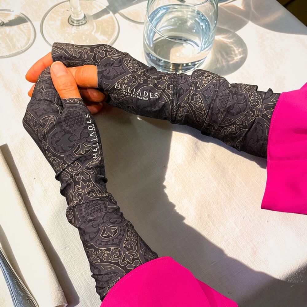 Heliades UPF 50+ Sun Gauntlets for hand and arm protection in black and gold print.