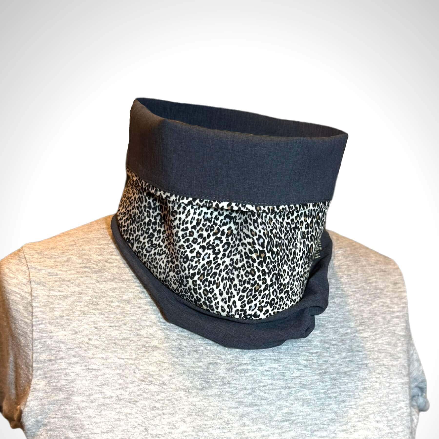 Front view of Sun Dickey with collar folded down half way, in shades of charcoal gray melange with fabulous animal pattern in shades of cream, black, brown styled with a gray crew neck t-shirt