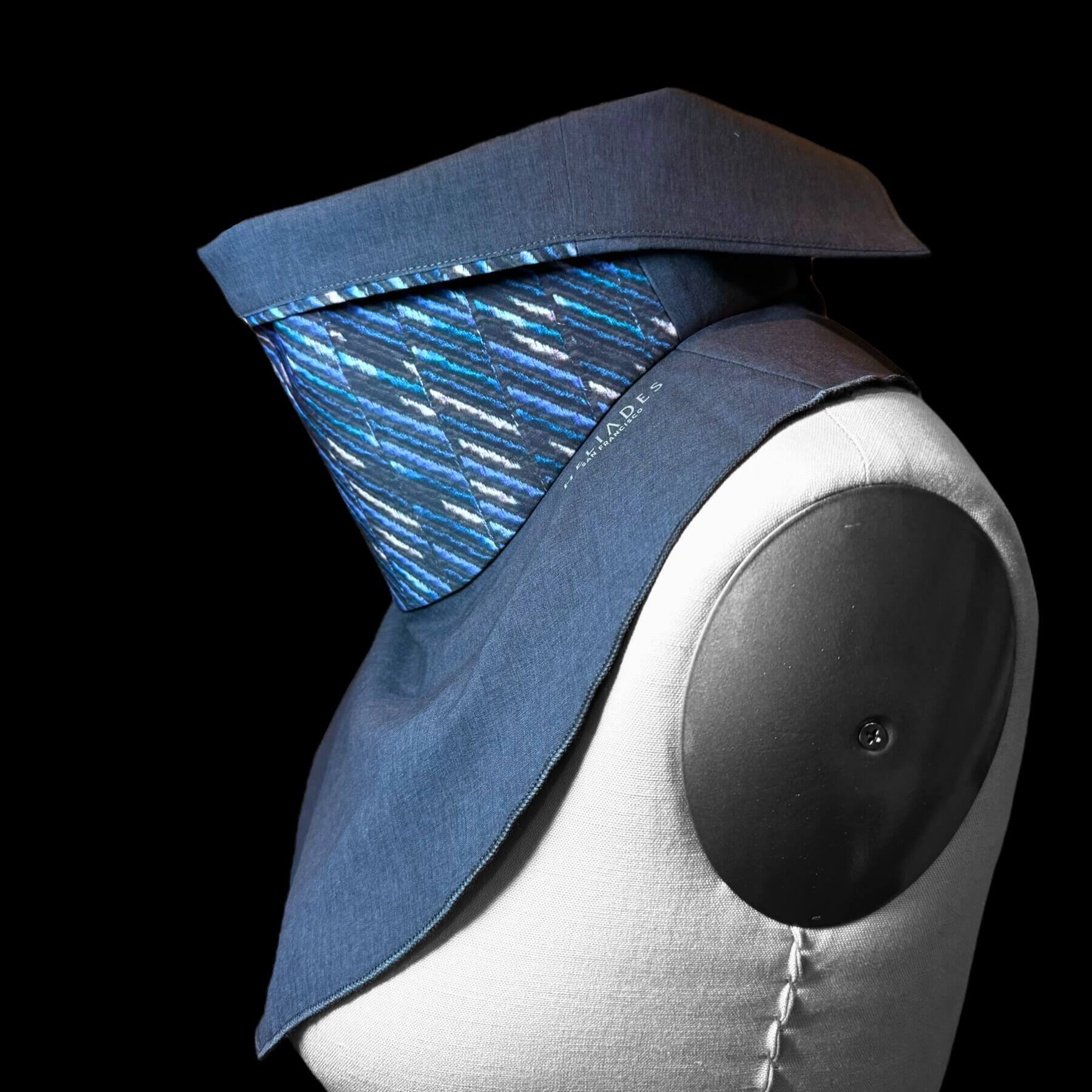 Side view of chic Sun Dickey with collar turned down shown on mannequin in charcoal gray melange with shades of blue, teal and white 'embroidered' (print) stripes in a diagonal pattern.