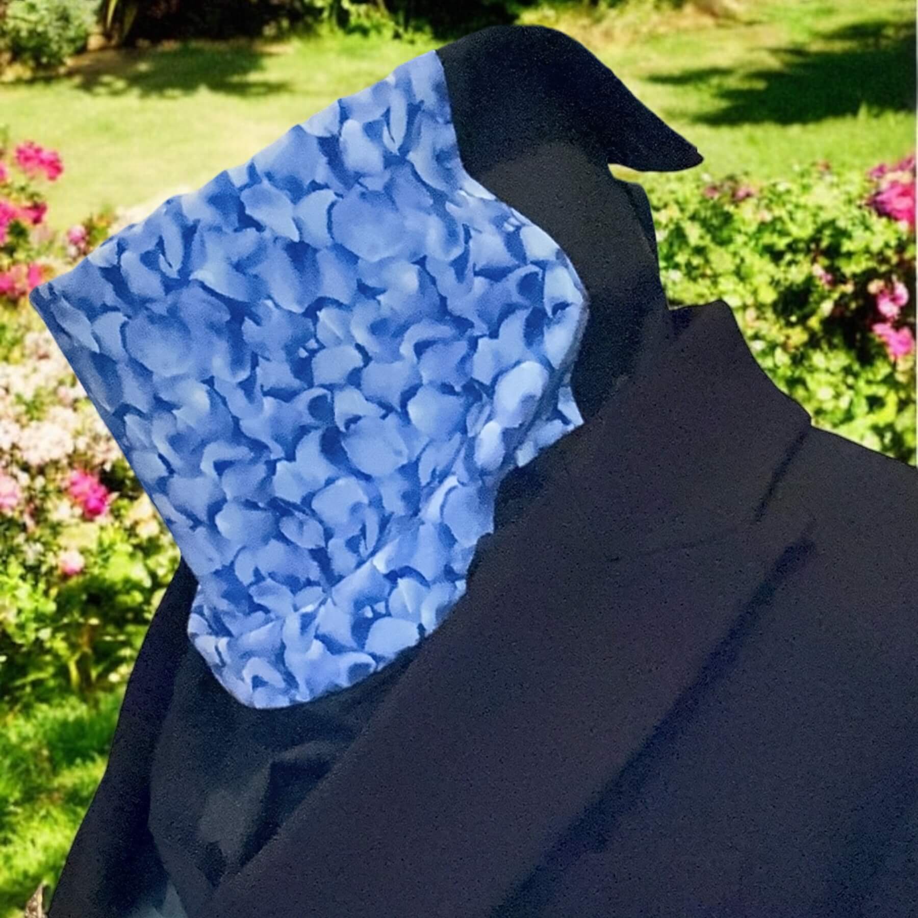 Navy blue blazer paired with Violet Blue Sun Dickey, in background are shrubs, flowers and grass.