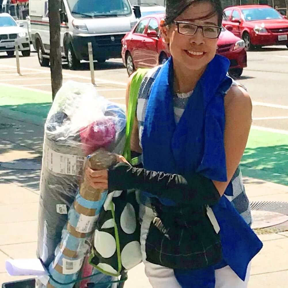 Heliades founder and chief maker with sun protective fabric rolls in San Francisco