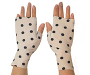 Heliades Sun Protective Clothing lightweight UV sun gloves in stylish patterned UPF 50 fabric. Shown is fashionable polka dot print with ballet pink and black colors. UV sun covered hands shown front