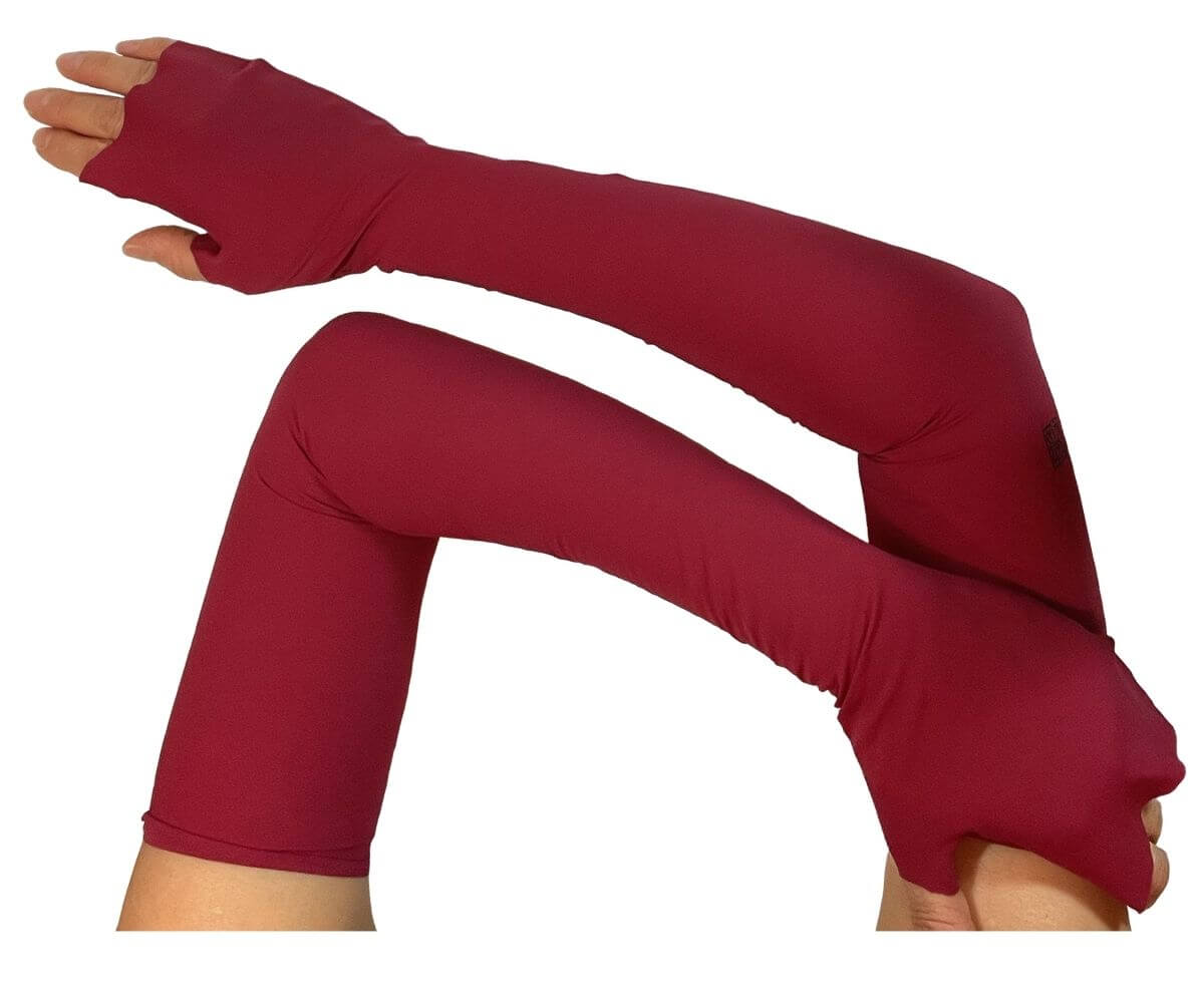 Heliades UPF 50 Sun Protective Clothing UV Arm Sleeves in fashionable deep red color, worn to block UV rays and protect skin from UV exposure.