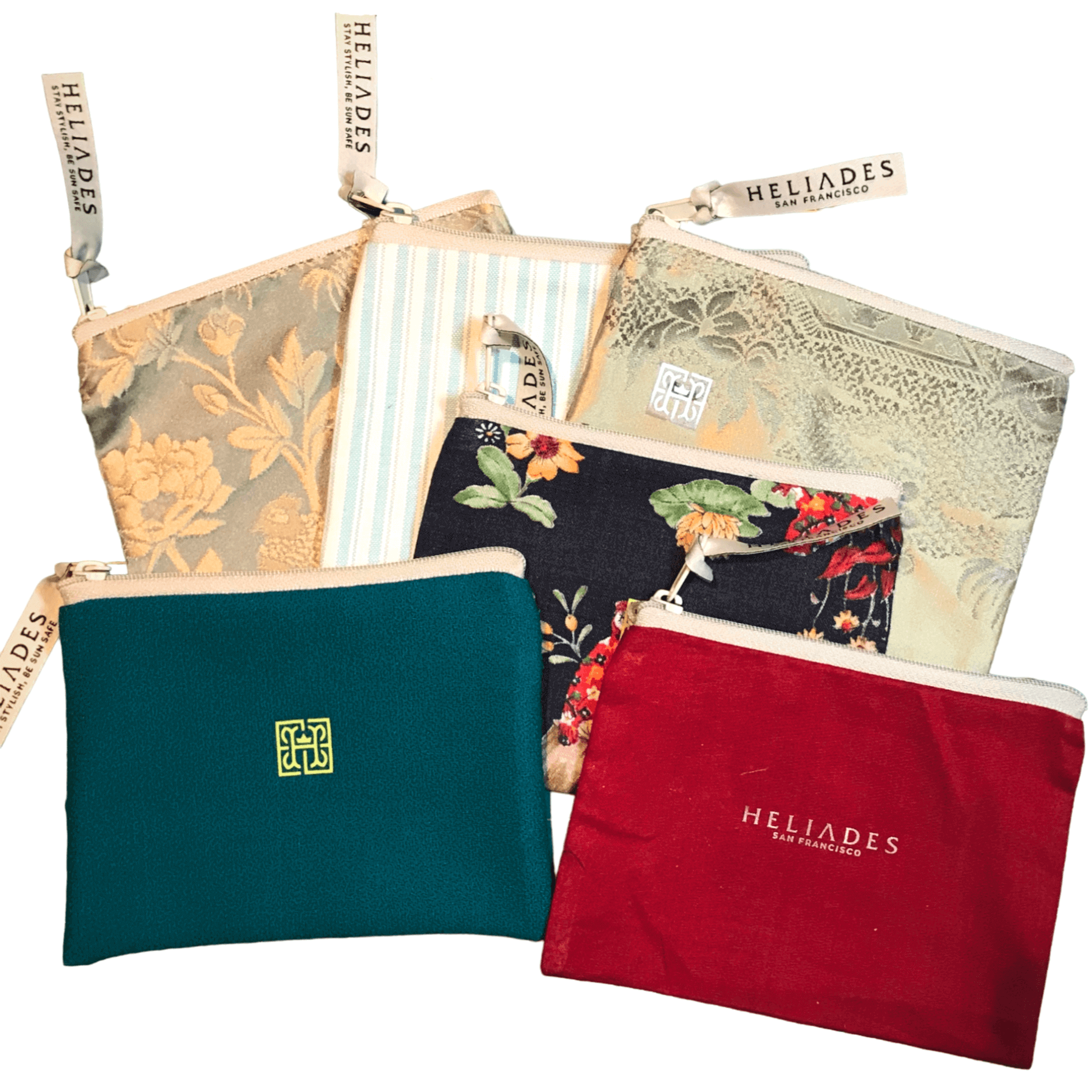 Organize your bag or purse with Heliades hand sewn zippered bags made from upcycled fabric. Free with purchase of UPF 50+ gloves or arm sleeves while supplies last. Shown teal with green logo, red with pink metallic trim, blue flowers print and green jacquard fabric bags.