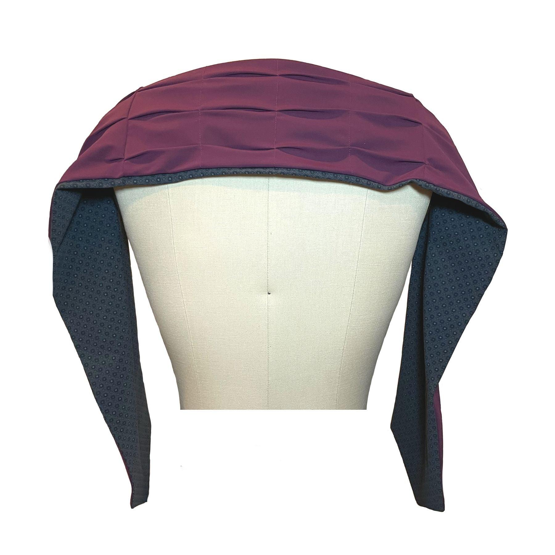 UPF 50+ Sun Protection scarf shown styled as shawl over shoulders, color is charcoal gray rosette print and reversible side is purple eggplant color.