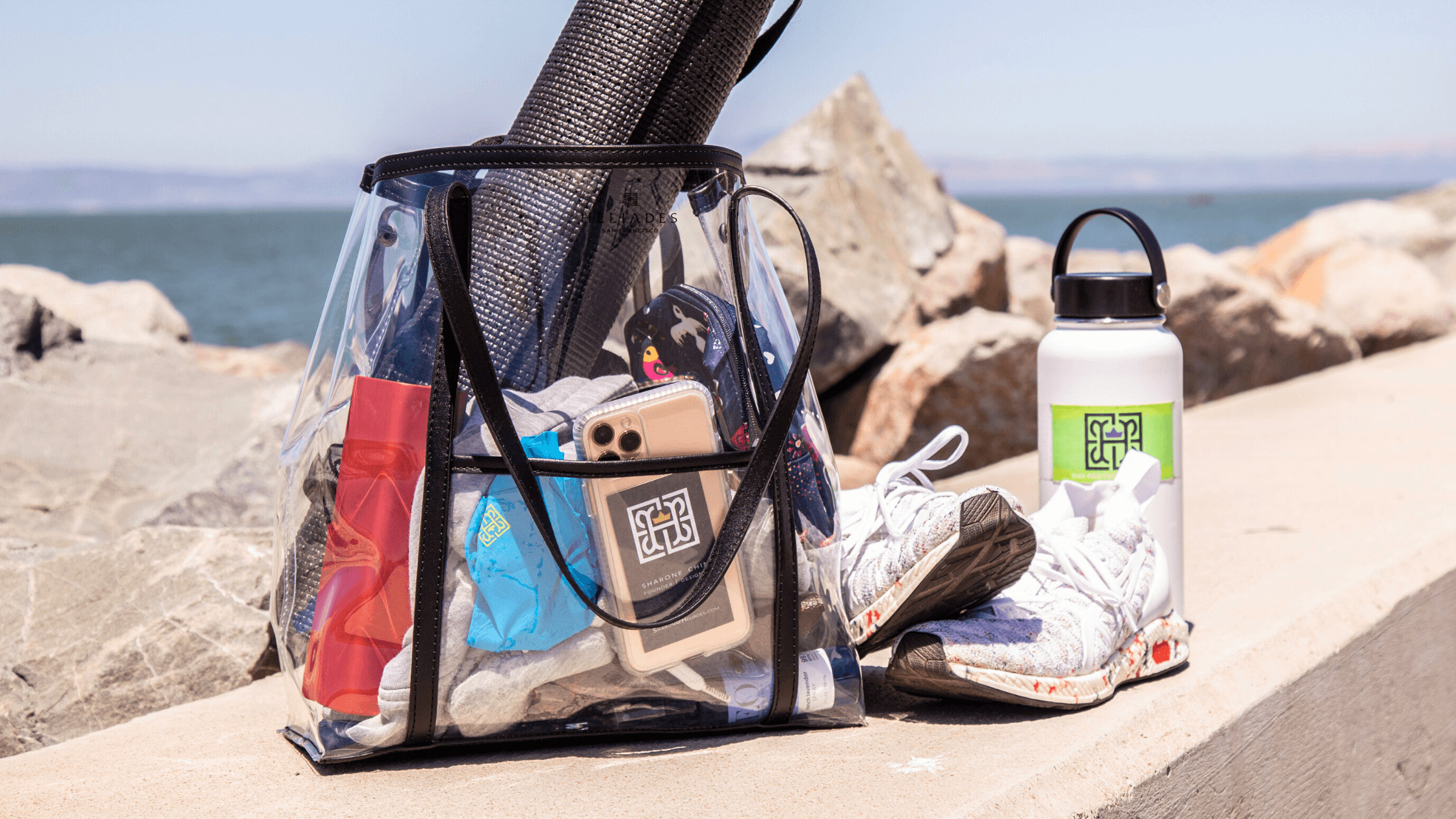 HELIADES UPF Clothing, Accessories. Stylish, lightweight designer clear bag carryall tote. Great for game day, travel and car errands. Spirit Flower accessory clip hand made with upcycled fabric.