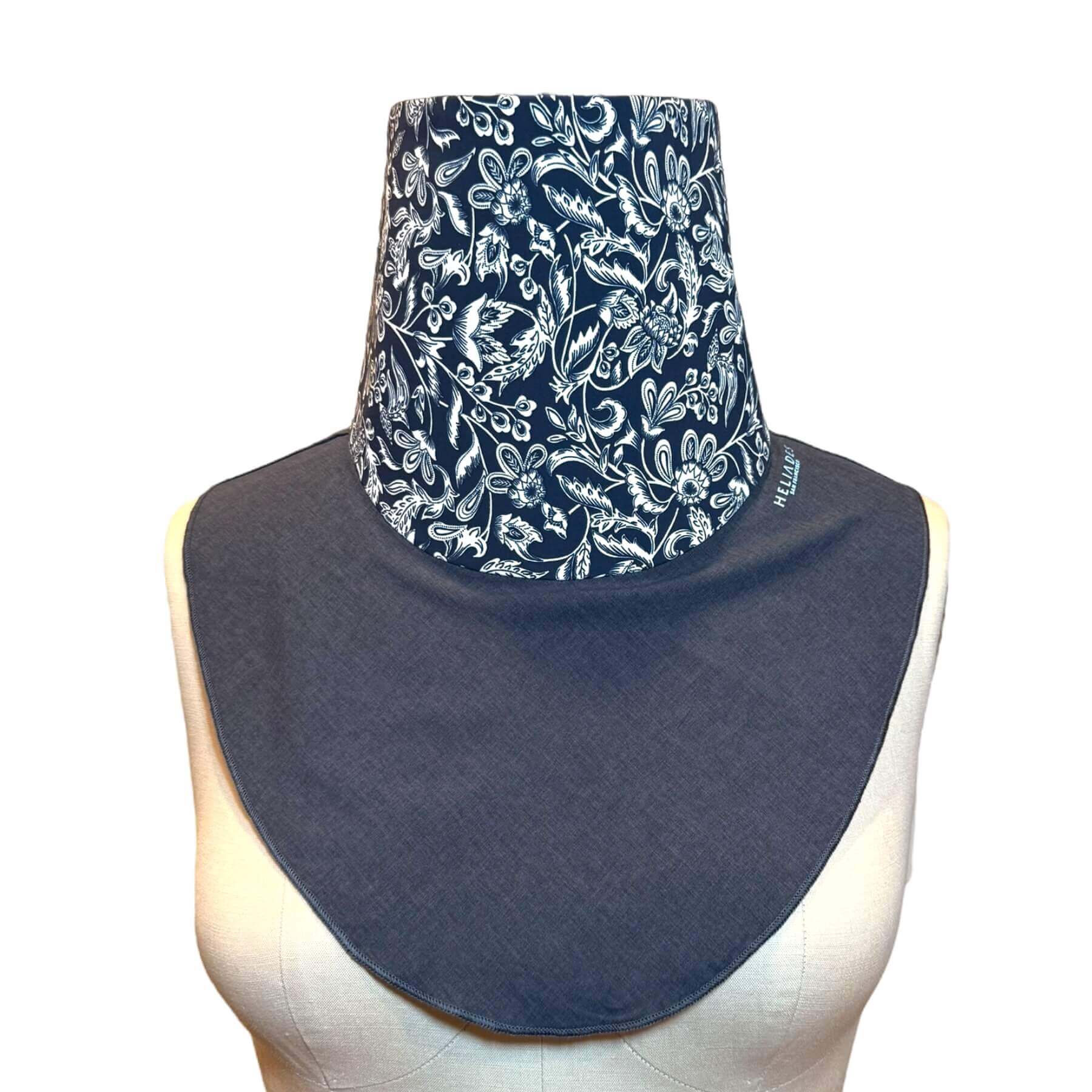 Stylish neck sun protection apparel - Fashion UV Sun Dickey is shown on mannequin in blue melange with intricate navy blue and white stylized floral pattern with leaves, flowers and scrolls.