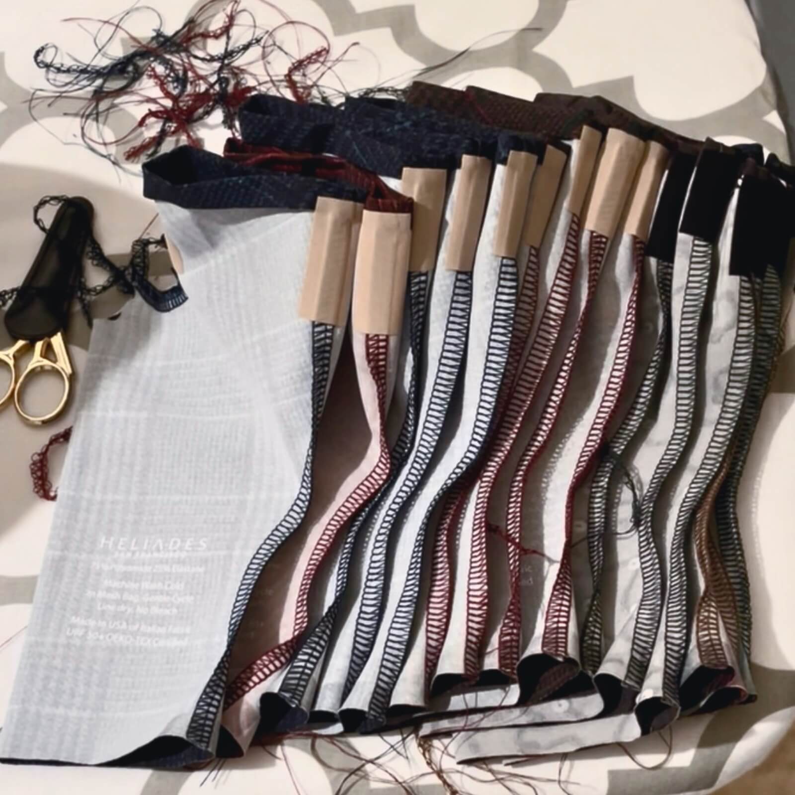 Inspecting finished UPF 50+ Sun Gauntlets for hand and arm protection.