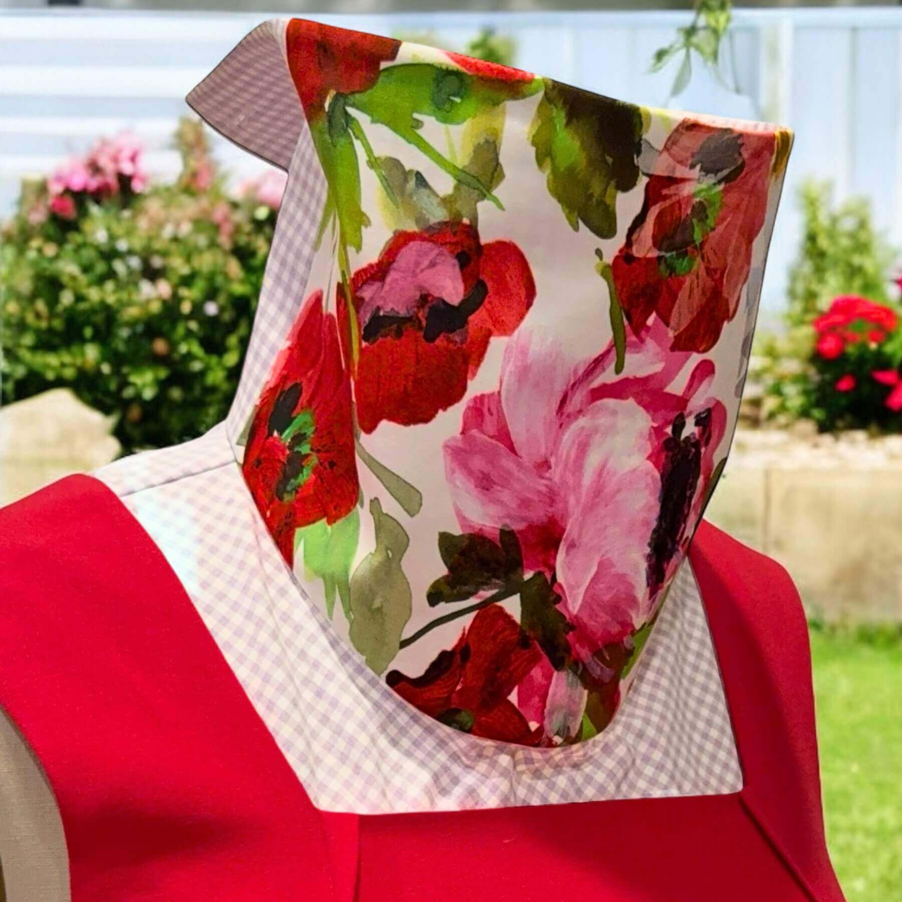 Stylish, colorful Sun Dickey for neck and chest sun protection paired with red dress.