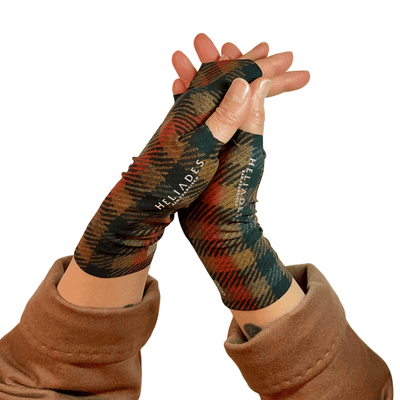 Heliades stylish sun protective hand gloves shown in black, red, golden brown classic plaid pattern worn with a Burberry coat. From the UV Sun Gauntlets Collection