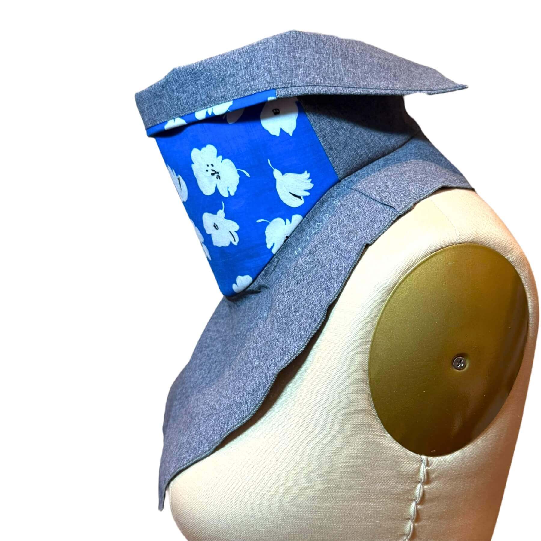 Heliades Chic UPF Sun Dickey shields skin in white, black painted flowers on sapphire blue fabric with blue melange dickey.