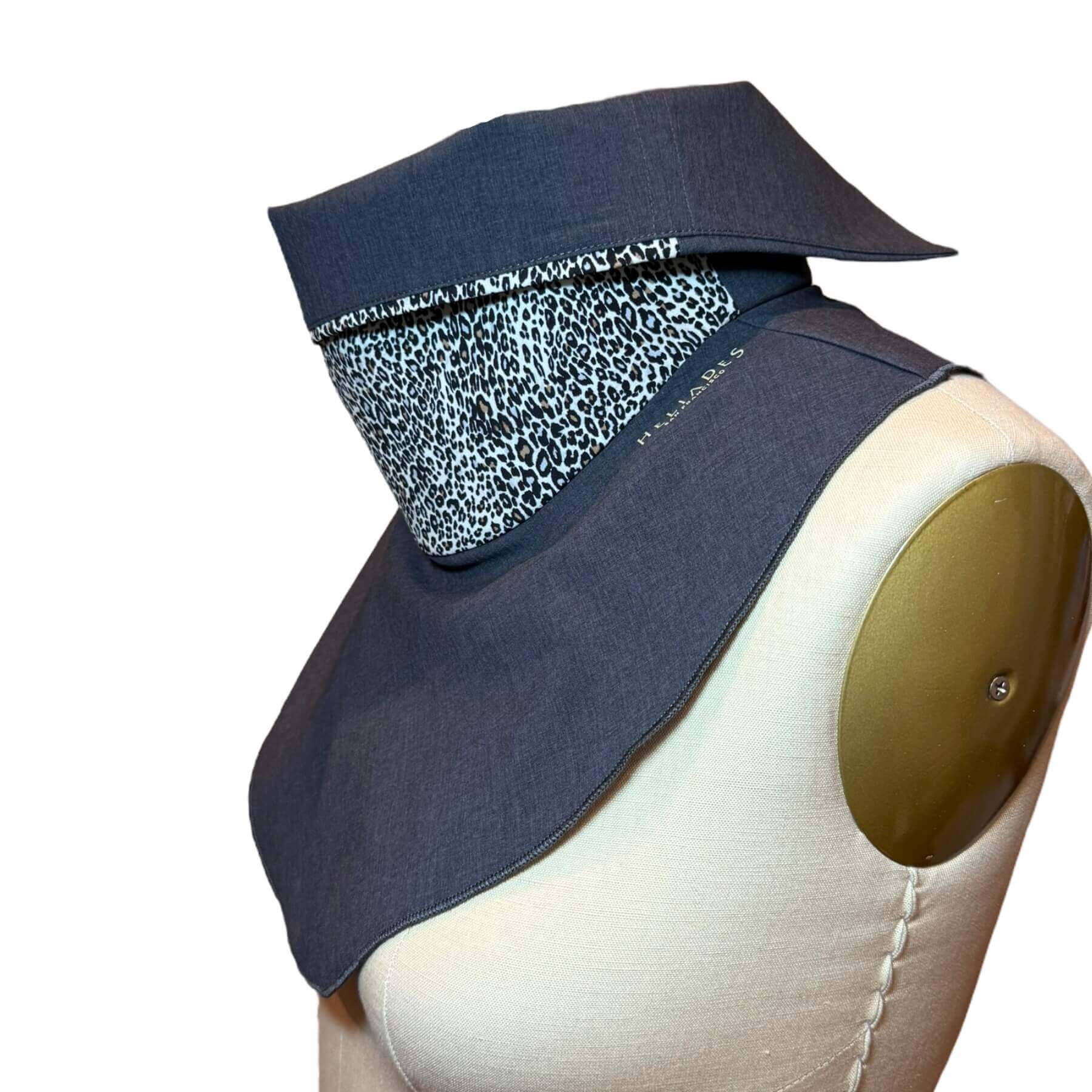 Side view of Sun Dickey shown with collar folded down in charcoal gray melange with fabulous animal pattern in shades of cream, black, brown