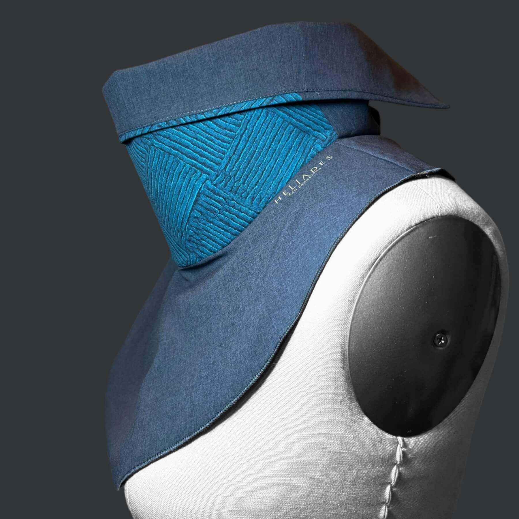 Fashion Sun Dickey side view with collar folded down to show gray contrast underneath. Shown on mannequin in charcoal gray melange with blue and teal detailed chenille basketweave print.