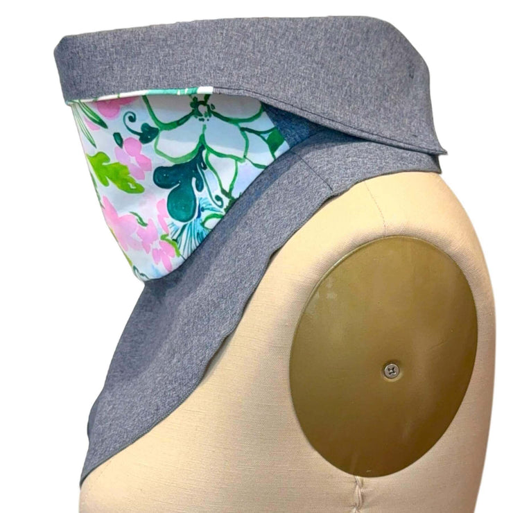 Fashion UPF50+ Sun Dickey side view of collar turned down, one button fastened in blue melange with pink, blue, green floral print
