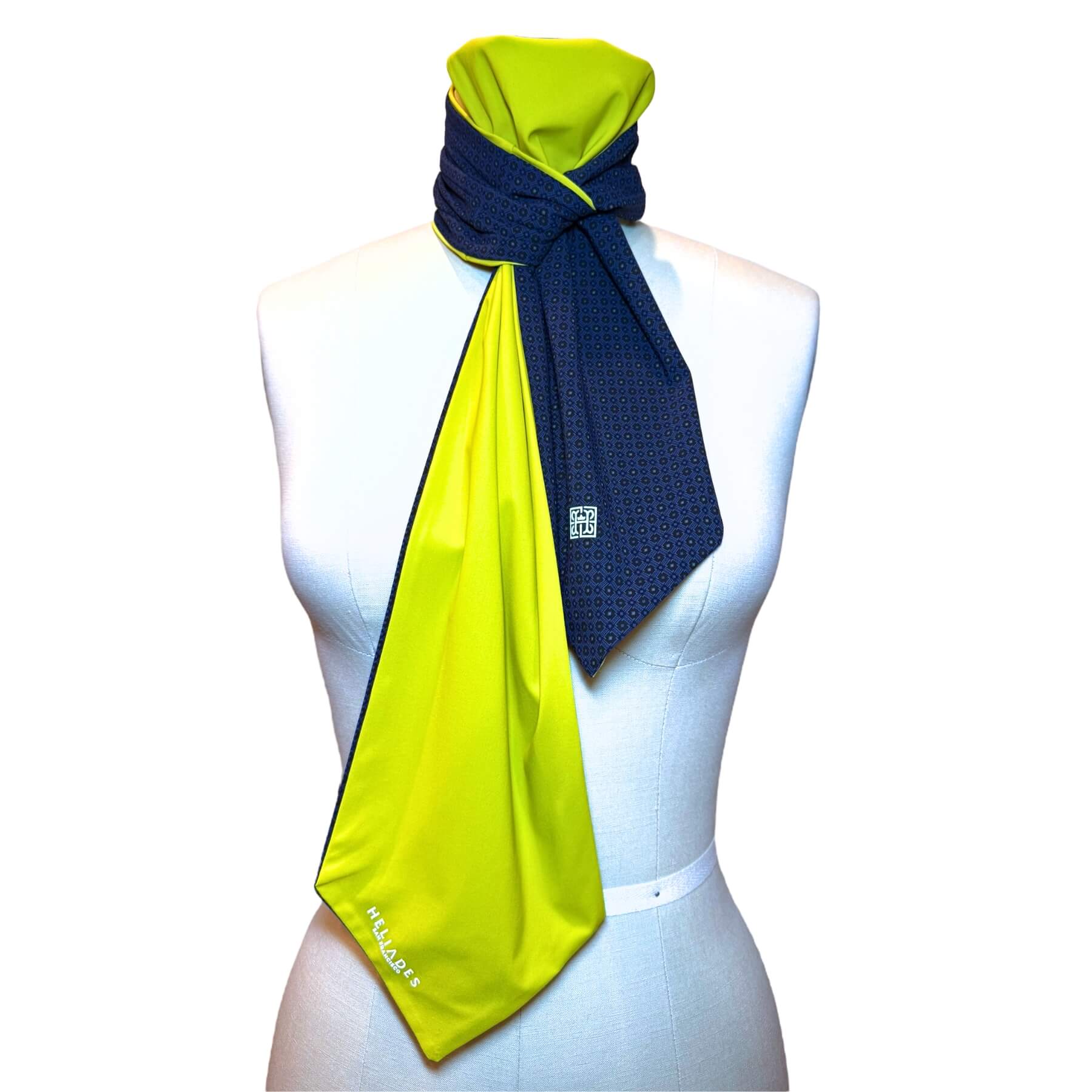 Sun protective scarf shown on mannequin in tanzanite blue rosette print with chartreuse color on reverse