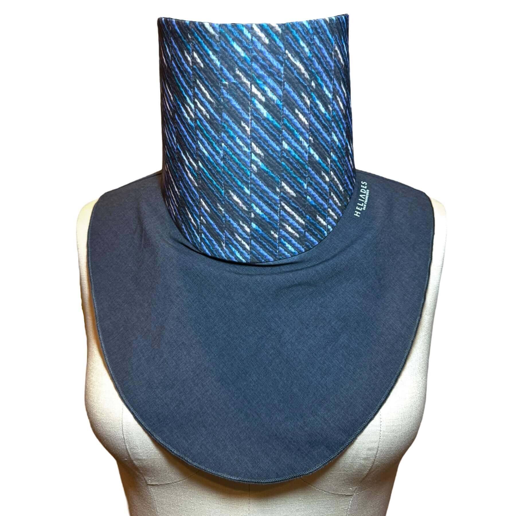 Sun protective scarf - Stylish UPF50+ protection for neck and chest shown on mannequin in charcoal gray melange with shades of blue, teal and white  'embroidered' (print) stripes in a diagonal pattern.