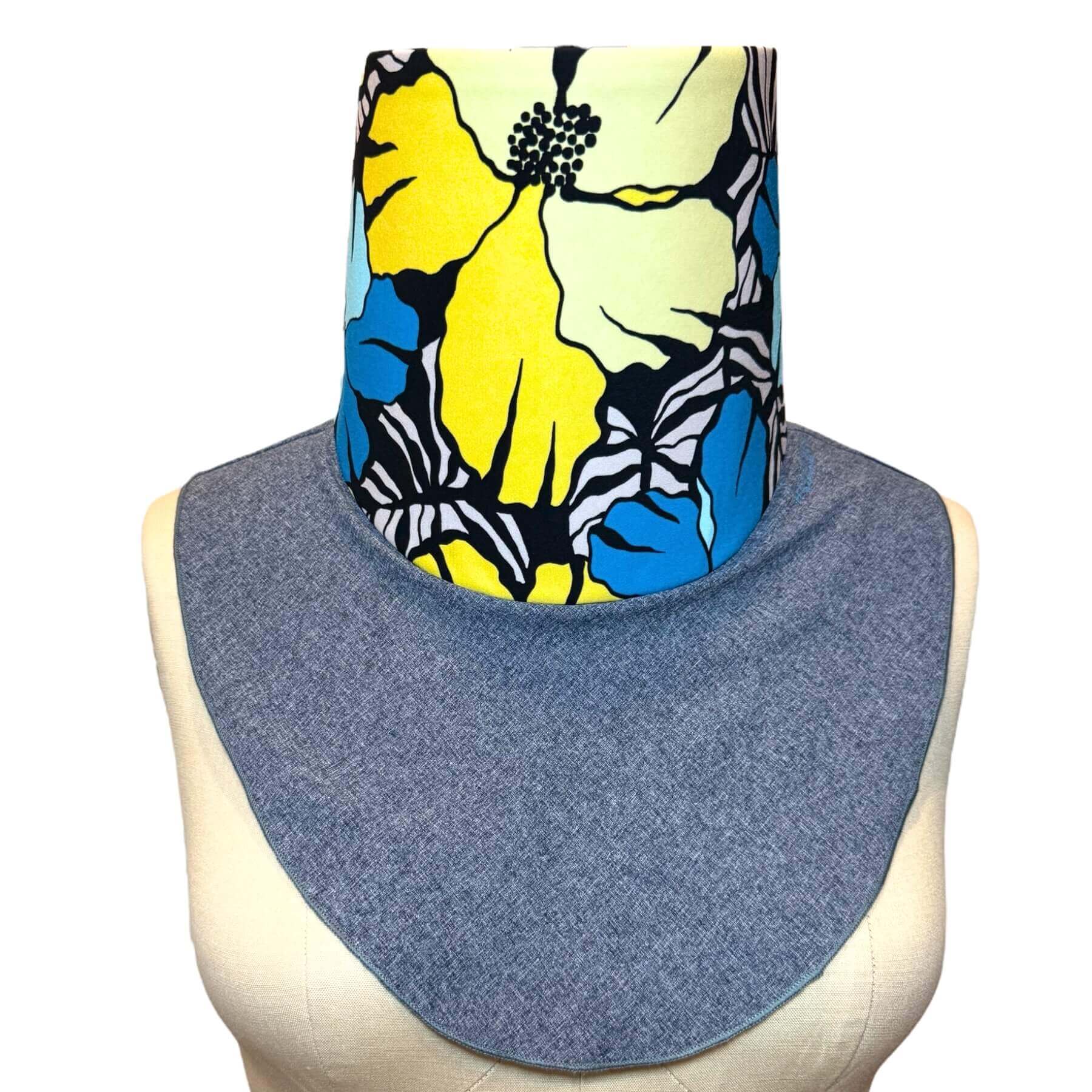 Sunblock Scarf-Stylish UV protection for everday elegance shown in blue melange with a pretty blue, yellow, black and white Hawaiian flower print