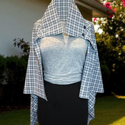 Gray Plaid UV Shoulder Wrap styled outdoors, a breathable UPF 50+ sun protective wrap for elegant everyday wear.