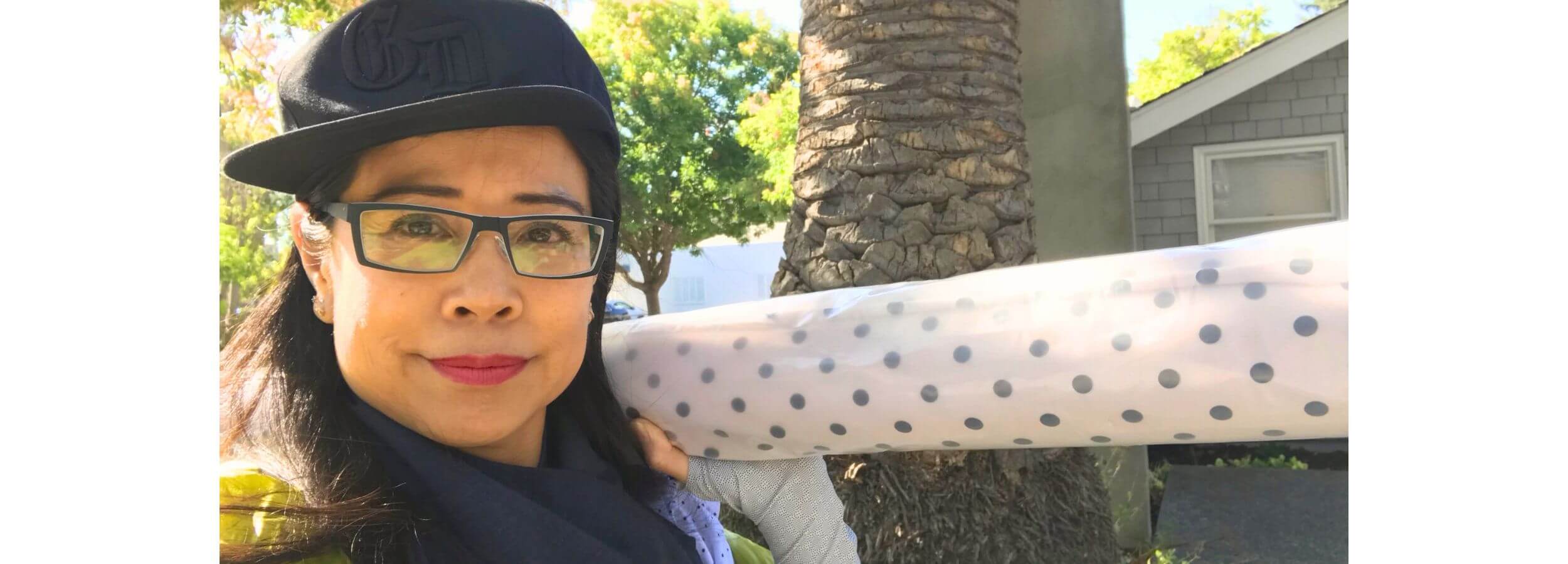 Heliades founder and designer Sharone with UPF50+ fabric, creating style-first sun protective clothing.