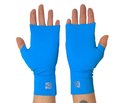 Heliades UPF 50 Sun Protective Clothing UV driving gloves in fashionable bright blue color with pink shimmer metallic trim. These hand gloves are fingerless and seamless
