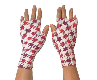Heliades UPF 50 Sun Protective Clothing UV driving gloves in fashionable houndstooth plaid print with red, purple, pink and beige colors. These hand gloves are fingerless and seamless.