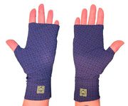 Heliades UPF 50 Sun Protective Clothing lightweight UV sun gloves in stylish patterned fabric. Shown is fashionable, elegant, unisex rosette print with tanzanite, blue, black colors. UV sun covered hands shown in gloves with bright green logo trim
