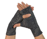 Heliades UPF 50 Sun Protective Clothing lightweight UV sun gloves in stylish patterned fabric. Shown is fashionable, elegant allover print with charcoal gray, black and gold colors. Hands shown clasped in sun gloves with silver reflective logo trim