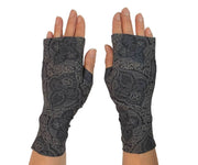 Heliades UPF 50 Sun Protective Clothing lightweight UV sun gloves in stylish patterned fabric. Shown is fashionable, elegant allover print with charcoal gray, black and gold colors. UV sun covered hands shown front