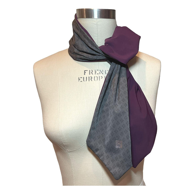 HELIADES UPF 50+ Sun Protection scarf for Neck Chest decolletage UV Ray Coverage shown styled as scarf tie at neck, color is gray with gold sparkle pattern glam rock with eggplant purple on reverse side.