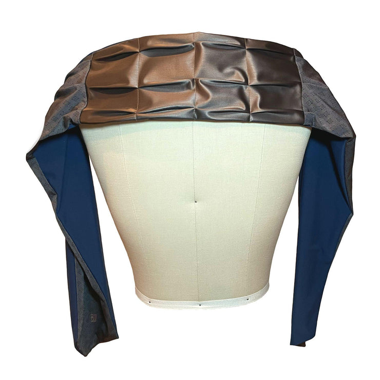 HELIADES UPF 50+ Sun Protection scarf for Neck Chest decolletage UV Ray Coverage shown styled as shawl over shoulders, color is bronze metallic and gray with gold sparkle print and reversible side is true navy blue color.