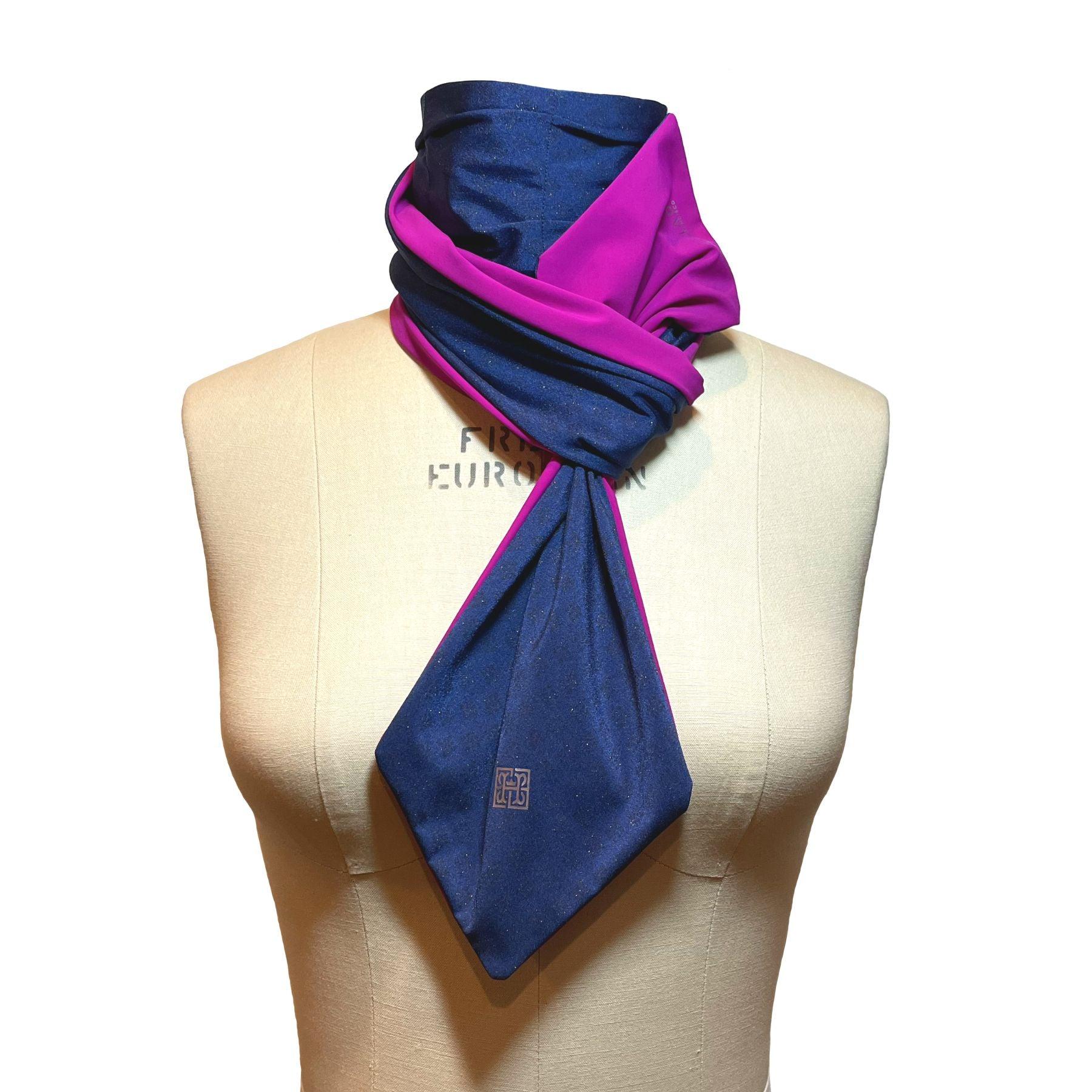 HELIADES UPF 50+ Sun Protection scarf shown styled as Bridgerton Cravat Tie, color is sapphire blue with gold sparkles and reversible side is pink fuchsia color.