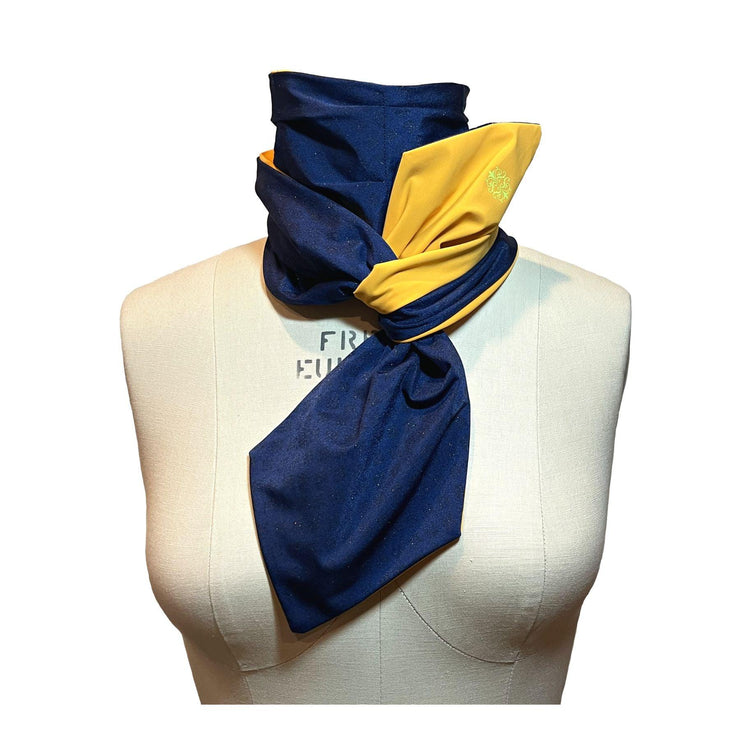 UPF 50+ Sun Protection scarf for Neck Chest decolletage UV Ray Coverage shown styled as Bridgerton Cravat Tie, color is marigold orange with pink constrast stitching and neon green trim, reversible side is sapphire blue with gold sparkles