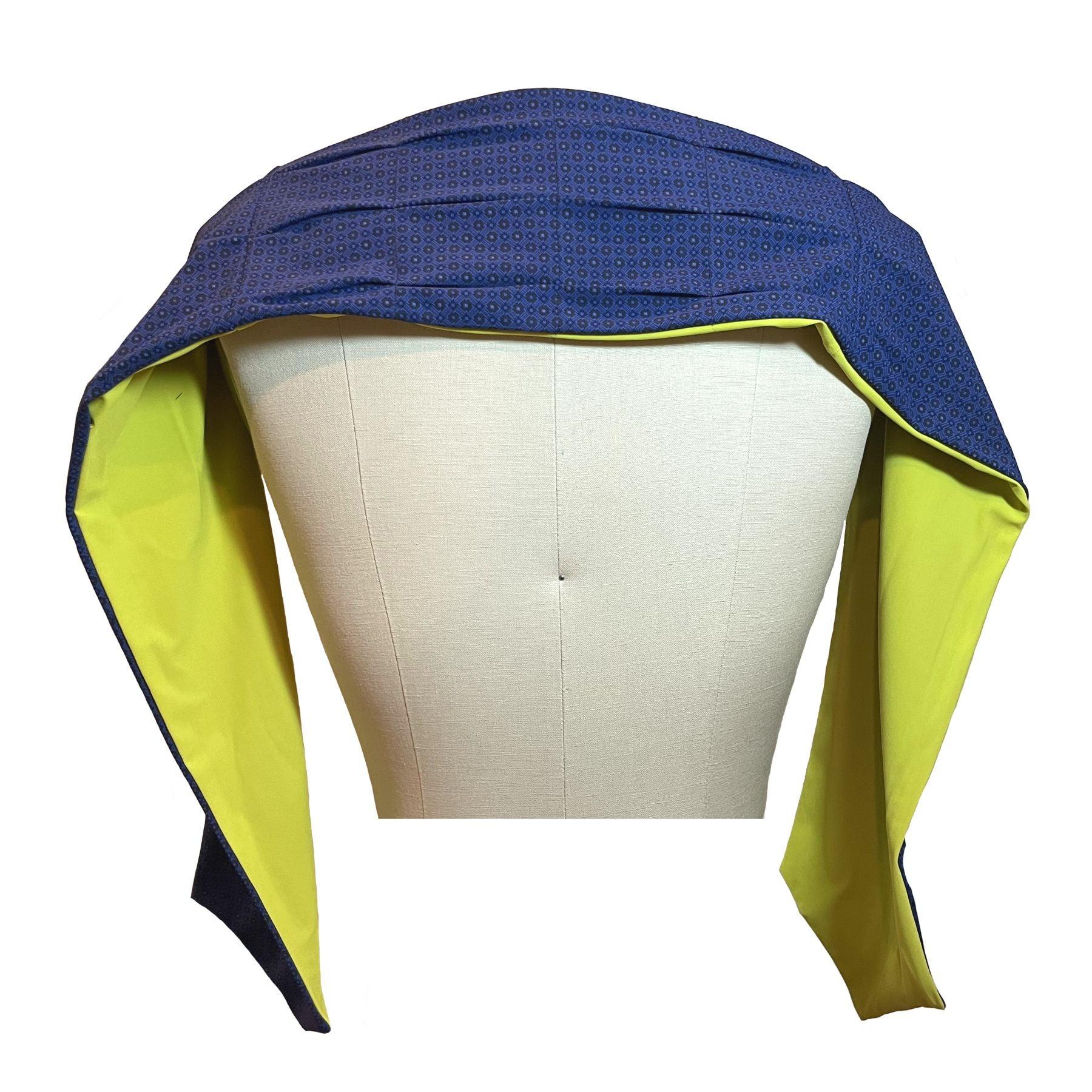 UPF 50+ Sun Protection scarf shown styled as shawl over shoulders, color is chartreuse, reversible side is tanzanite blue rosette in repeating pattern.