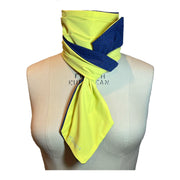 UPF 50+ Sun Protection scarf for Neck Chest decolletage UV Ray Coverage shown styled as Bridgerton Cravat Tie, color is lemon custard yellow, reversible side is tanzanite blue and black rosettes in repeating pattern.