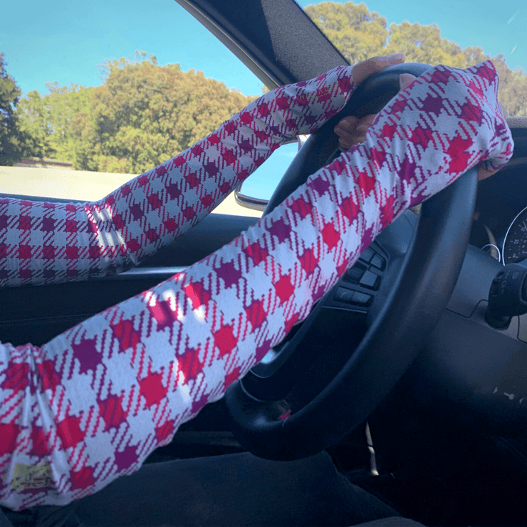 UPF 50+ sun protection arm sleeves in Coigach District Plaid print with colors, red, plum on white and beige background. Gloves block 98% UV rays, seamless, fingerless for driving