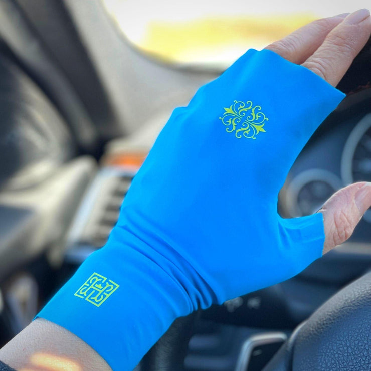 HELIADES UPF50+ sun protective fingerless, tagless gloves in Bright Blue Mood color on driving wheel. All fabric 98% UV blocking and OEKO-TEX certified. Purchase a pair of blue gloves, HELIADES will donate $75 towards aid for Ukraine.
